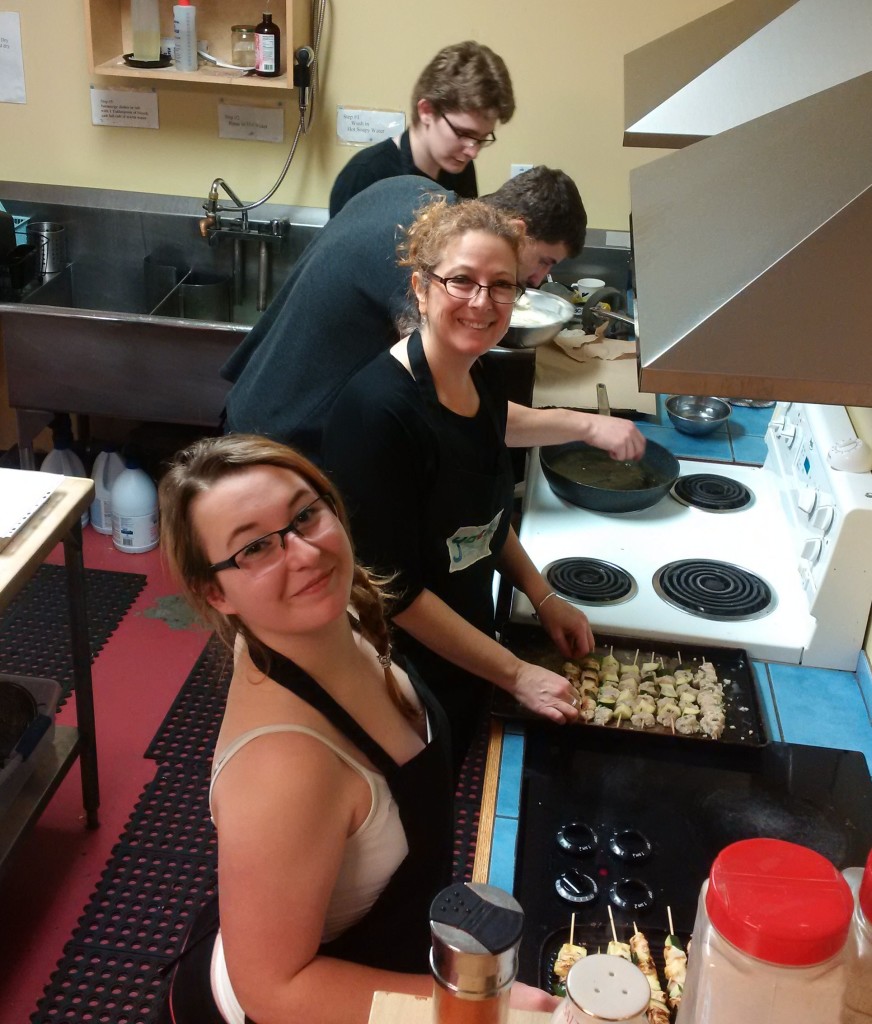 Evan, Morgan, Vanessa, and Brittney cooking on the line in the YACK kitchen.
